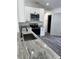 Modern kitchen featuring gray countertops, white cabinets, and stainless steel appliances at 3722 S Cranberry Blvd, North Port, FL 34286