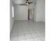 Bright living room with tile flooring and views to a back door and bedrooms at 3722 S Cranberry Blvd, North Port, FL 34286