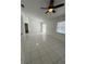 Bright living room with tile flooring, a ceiling fan, and sliding glass door at 3722 S Cranberry Blvd, North Port, FL 34286