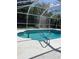 Beautiful pool with a handrail, set within a screened enclosure, providing privacy at 3722 S Cranberry Blvd, North Port, FL 34286