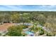 Community aerial view featuring a pool, lush greenery, mature trees and scenic neighborhood streets at 3864 Chatsworth Greene Ct # 10, Sarasota, FL 34235
