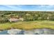 Aerial view showcasing the community's serene setting with lake, golf course and lush landscaping at 3864 Chatsworth Greene Ct # 10, Sarasota, FL 34235