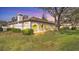 Home exterior showcases a screened lanai, lush landscaping and views of the manicured lawn at 3864 Chatsworth Greene Ct # 10, Sarasota, FL 34235