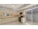 Bright kitchen with white cabinets, modern black appliances, and a slider to an outdoor patio at 3864 Chatsworth Greene Ct # 10, Sarasota, FL 34235