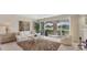 Bright living room featuring neutral tones, sliding doors with screened porch, and golf course views at 3864 Chatsworth Greene Ct # 10, Sarasota, FL 34235