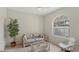 Inviting room offers a tranquil space with comfortable seating and a garden view from the window at 3864 Chatsworth Greene Ct # 10, Sarasota, FL 34235