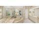 Spacious main bathroom with double sinks, a soaking tub, and floral wallpaper at 3864 Chatsworth Greene Ct # 10, Sarasota, FL 34235