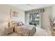 Serene main bedroom with golf course views, neutral decor, and slider access to the lanai at 3864 Chatsworth Greene Ct # 10, Sarasota, FL 34235