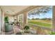 Inviting screened-in patio with golf course views offers relaxation and seamless indoor-outdoor living at 3864 Chatsworth Greene Ct # 10, Sarasota, FL 34235