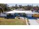 An aerial view of a charming single-story home with landscaping and a white metal roof at 4210 Pandora Rd, Venice, FL 34293