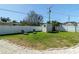 Spacious backyard with white fence, shed, and lounging chairs perfect for relaxing at 4210 Pandora Rd, Venice, FL 34293