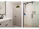 Modern bathroom features a glass-enclosed shower, stylish vanity, and ample storage within shaker cabinets at 4210 Pandora Rd, Venice, FL 34293
