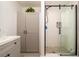 Modern bathroom features a glass-enclosed shower, stylish vanity, and ample storage within shaker cabinets at 4210 Pandora Rd, Venice, FL 34293