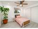 Charming bedroom with a ceiling fan, bright window, and a closet at 4210 Pandora Rd, Venice, FL 34293