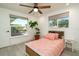 Bright bedroom featuring a ceiling fan and ample natural light from two windows at 4210 Pandora Rd, Venice, FL 34293