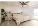 Cozy bedroom features a ceiling fan, stylish nightstands, and a modern lamp at 4210 Pandora Rd, Venice, FL 34293