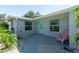 Inviting home exterior with a blue front door, manicured landscaping, and a welcoming entrance at 4210 Pandora Rd, Venice, FL 34293