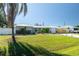 Charming home with a well-maintained lawn, palm trees, and a metal roof at 4210 Pandora Rd, Venice, FL 34293