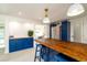 Kitchen area featuring custom blue cabinets, butcher block countertops, and stainless steel appliances at 4210 Pandora Rd, Venice, FL 34293