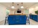 Kitchen island featuring custom blue cabinets, butcher block countertops, and pendant lighting at 4210 Pandora Rd, Venice, FL 34293