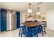 Kitchen with a large center island, blue cabinets, butcher block countertops, and stainless steel refrigerator at 4210 Pandora Rd, Venice, FL 34293