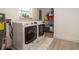 Functional laundry room with modern washer and dryer, storage shelving, and bright natural light at 4210 Pandora Rd, Venice, FL 34293
