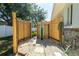 Outdoor shower featuring a wooden privacy fence, stone flooring, and surfboard decor at 4210 Pandora Rd, Venice, FL 34293