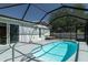 Screened-in pool area with a clear blue pool and comfortable seating at 4210 Pandora Rd, Venice, FL 34293