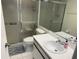 Bathroom features a shower with glass sliding doors, a sink, toilet, and tiled floors at 435 30Th W Ave # D303, Bradenton, FL 34205