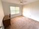Carpeted room with a window, small shelves, and a wooden desk at 435 30Th W Ave # D303, Bradenton, FL 34205