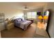 Cozy bedroom featuring a ceiling fan, matching nightstands and lamps, and a warm, neutral carpet at 435 30Th W Ave # D303, Bradenton, FL 34205