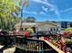 Charming clubhouse surrounded by vibrant tropical plants and a welcoming walkway at 435 30Th W Ave # D303, Bradenton, FL 34205