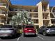 A multi-story condominium complex with ample parking on a sunny day at 435 30Th W Ave # D303, Bradenton, FL 34205
