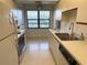 Bright kitchen features modern appliances, ample counter space, and a window offering pleasant views at 435 30Th W Ave # D303, Bradenton, FL 34205
