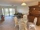 Open-concept living and dining area with a view of the patio and outdoor scenery at 435 30Th W Ave # D303, Bradenton, FL 34205