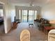 Comfortable living room with a sliding door to the balcony, providing a view of the trees and lake at 435 30Th W Ave # D303, Bradenton, FL 34205