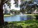 Scenic view of the pond with fountains surrounded by lush greenery and buildings at 435 30Th W Ave # D303, Bradenton, FL 34205