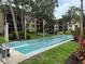 Enjoy leisure time with shuffleboard courts surrounded by benches, lush greenery, and mature trees at 435 30Th W Ave # D303, Bradenton, FL 34205