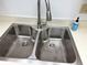 Stainless steel double basin sink with modern faucet and bright countertops, complemented by clean white walls at 435 30Th W Ave # D303, Bradenton, FL 34205