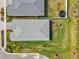 Aerial view of a home's roof with a lush backyard and a neighbor's trampoline for outdoor enjoyment at 44325 Saddlewood Ct, Punta Gorda, FL 33982