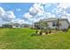 Manicured backyard lawn and landscaping provides a peaceful view of the neighborhood in a quiet community at 44325 Saddlewood Ct, Punta Gorda, FL 33982