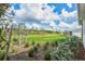 Backyard featuring lush greenery, landscaping, and a serene view at 44325 Saddlewood Ct, Punta Gorda, FL 33982