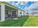 A green lawn with a screened-in patio and seating provides a perfect view for outdoor relaxation and entertainment at 44325 Saddlewood Ct, Punta Gorda, FL 33982
