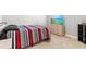 Bedroom with a large bed, dresser, TV, and carpeted floors at 44325 Saddlewood Ct, Punta Gorda, FL 33982