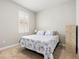 Cozy bedroom featuring a floral-patterned bedspread and bright window at 44325 Saddlewood Ct, Punta Gorda, FL 33982