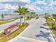 Community entrance lined with palm trees, lush landscaping, and a water feature creates a grand sense of arrival at 44325 Saddlewood Ct, Punta Gorda, FL 33982