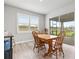 Dining area features hardwood floors, bright windows and access to a screened lanai at 44325 Saddlewood Ct, Punta Gorda, FL 33982