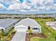 Well-manicured lawn and landscaping surround this single-Gathering home with a brick driveway in a desirable community at 44325 Saddlewood Ct, Punta Gorda, FL 33982