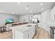 Bright, open-concept kitchen with white cabinets, stainless steel appliances, and an island at 44325 Saddlewood Ct, Punta Gorda, FL 33982