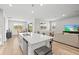 Open-concept kitchen with island, stainless appliances and hardwood floors at 44325 Saddlewood Ct, Punta Gorda, FL 33982